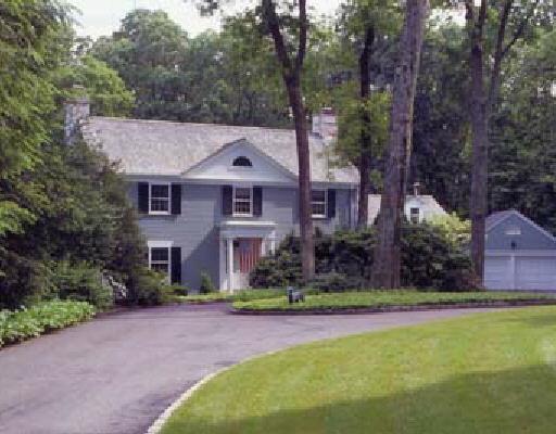 182 Wahackme Road New Canaan, CT 06840 - Photo 1 of 1 a front view of a house with a yard and large trees