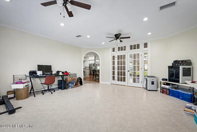 a living room with furniture a potted plant and a chandelier