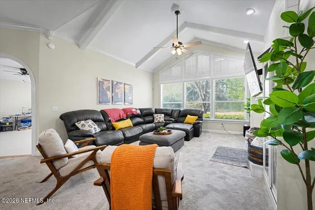 a living room with furniture and a chandelier