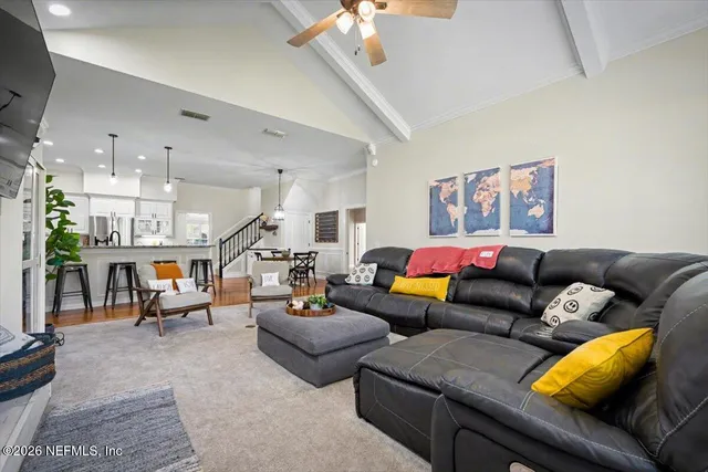 a living room with furniture and a flat screen tv