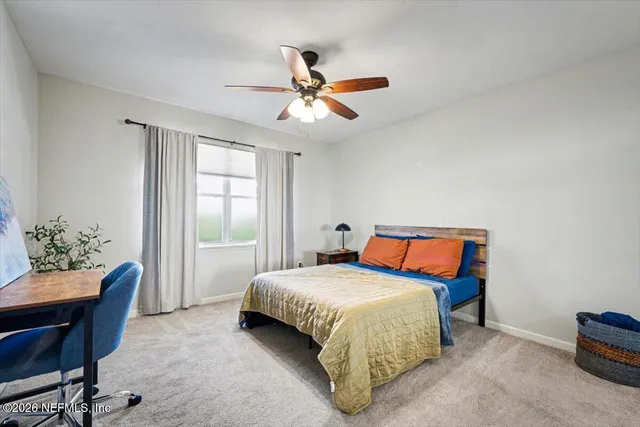 a spacious bedroom with a bed and a couch