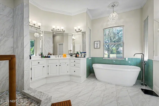 a spacious bathroom with a double vanity sink a mirror and shower