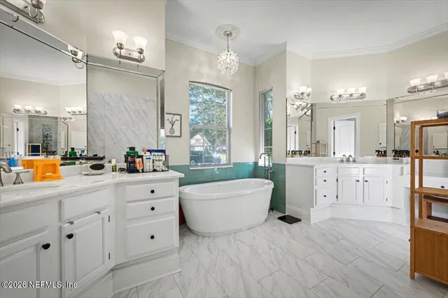 a white bath tub sitting in a bathroom and mirror