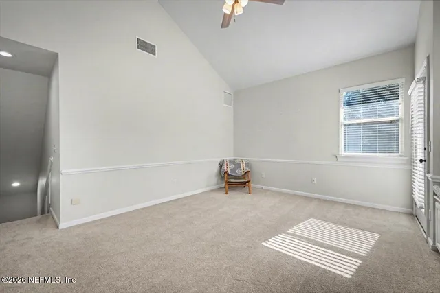 a view of a swimming pool and lounge chairs
