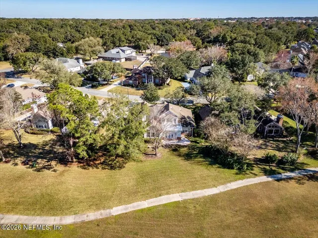 an aerial view of residential house with outdoor space and trees