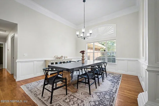 a view of a dining room with furniture window and wooden floor