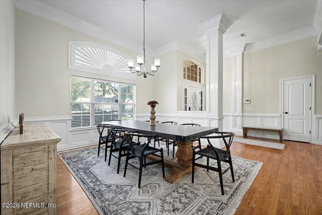a view of a dining room with furniture window and wooden floor