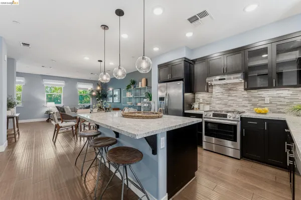 a kitchen with granite countertop a stove top oven