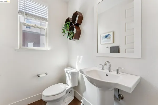 a white toilet sitting next to a bathroom sink