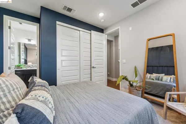 a bedroom with a bed and a mirror