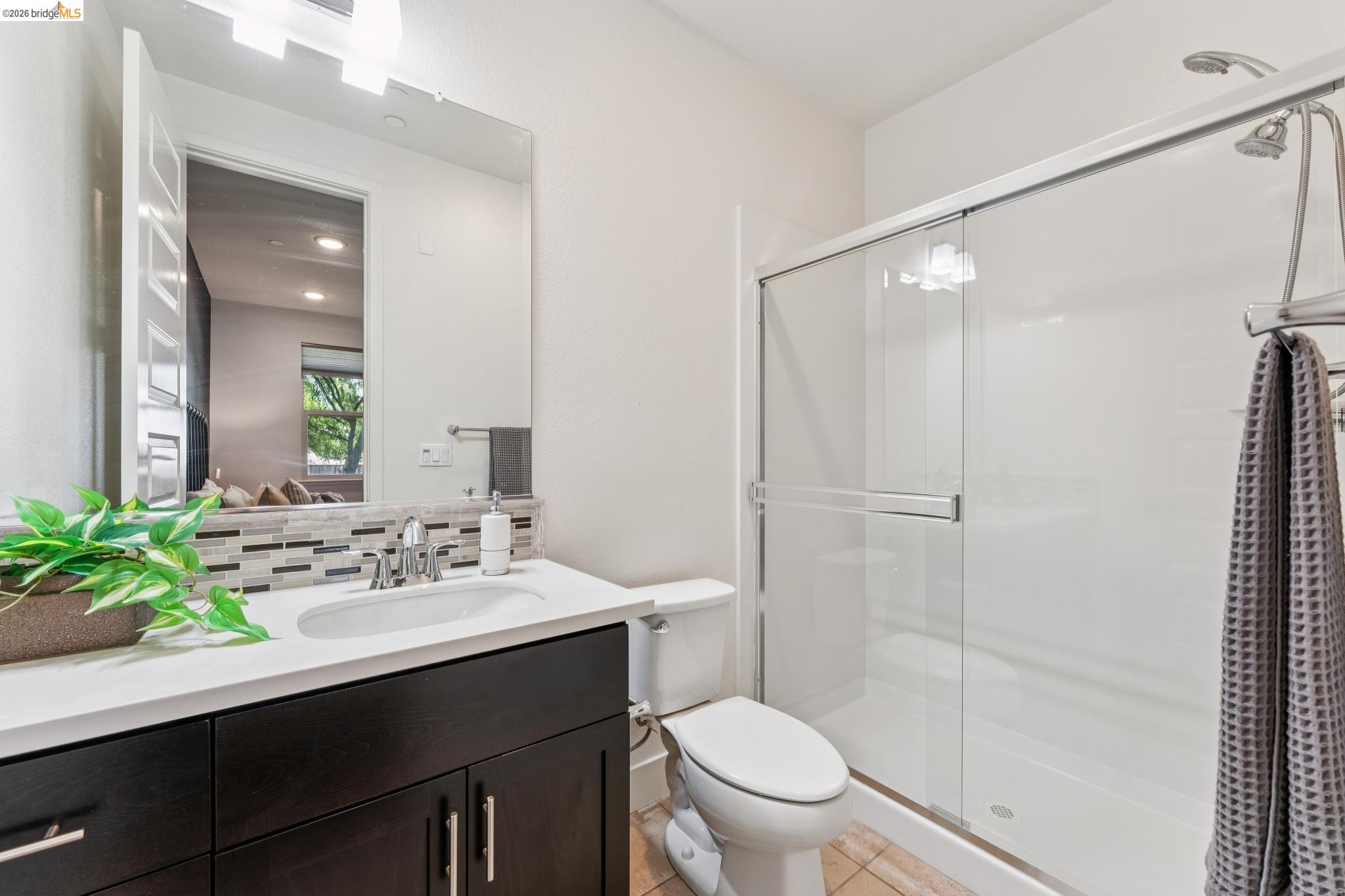 489 Diller Street Alameda, CA 94501 - Photo 26 of 60 Full bathroom featuring vanity, a shower stall, tasteful backsplash, and light tile patterned floors