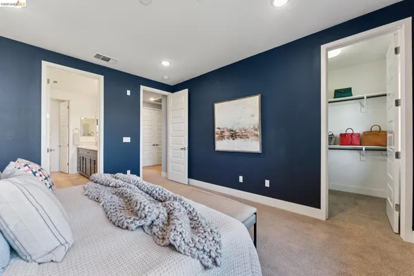 a bedroom with a bed and a lamp
