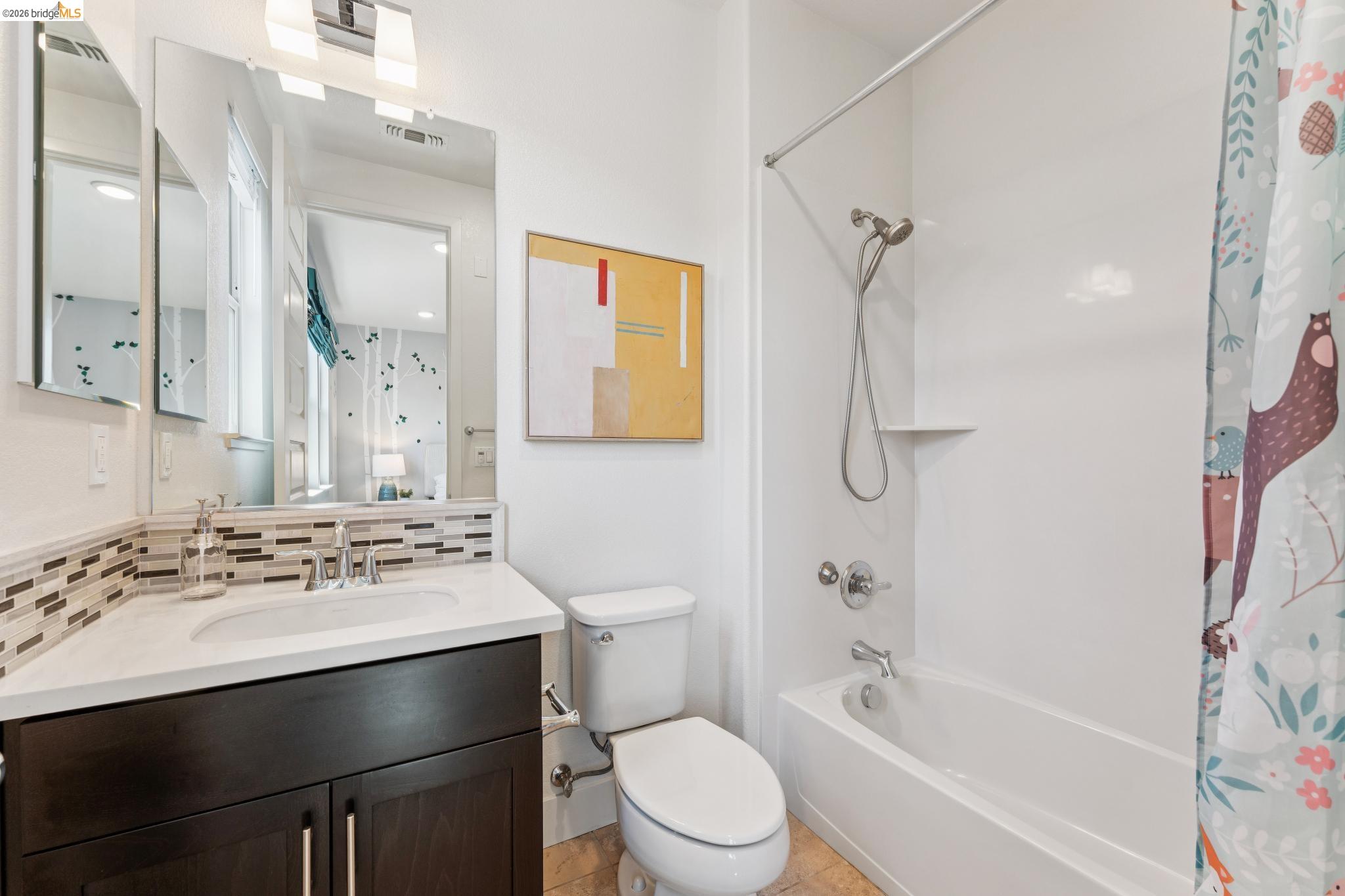 489 Diller Street Alameda, CA 94501 - Photo 42 of 60 Full bath with vanity, shower / bath combo, tasteful backsplash, and light tile patterned floors