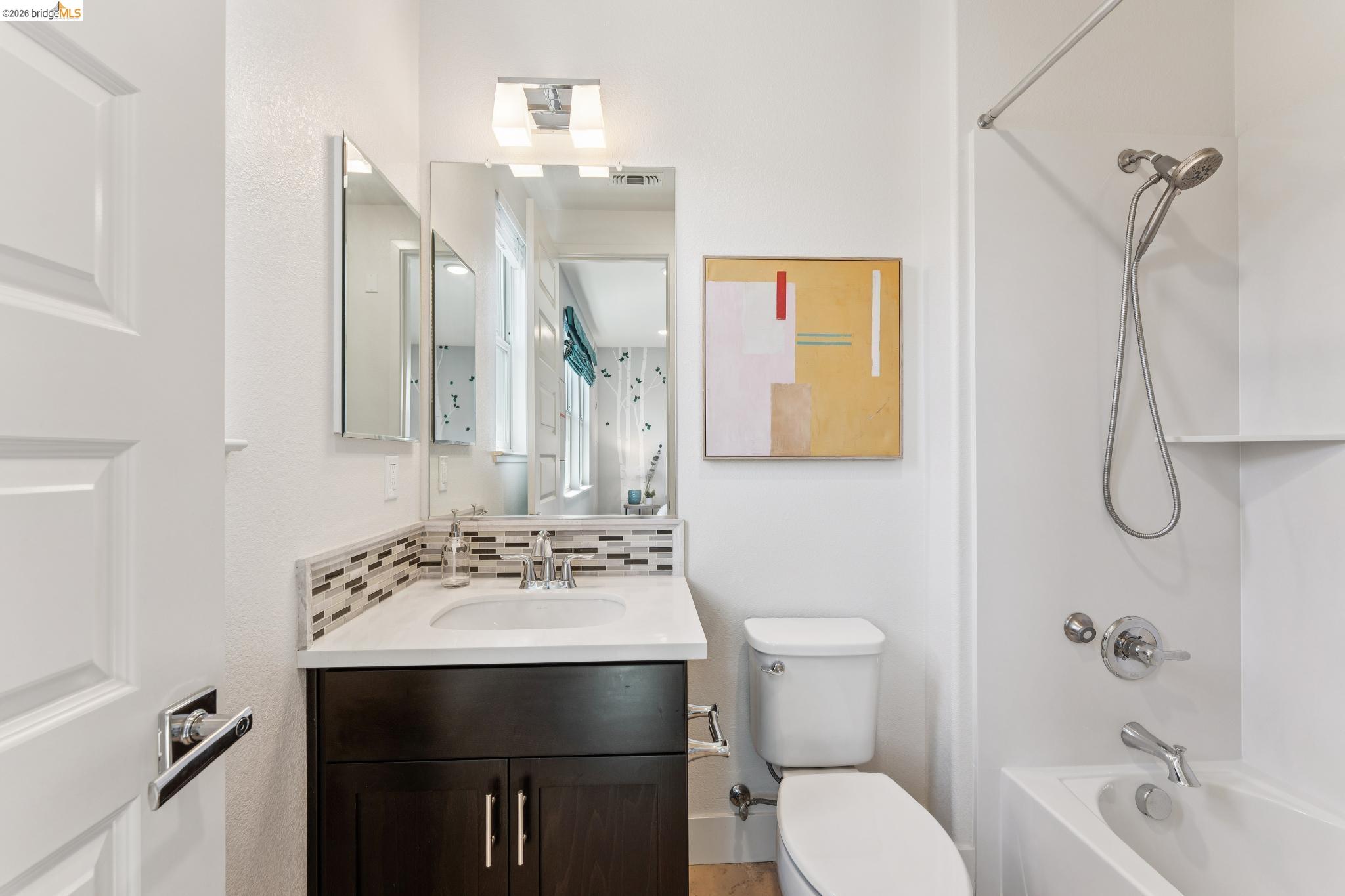489 Diller Street Alameda, CA 94501 - Photo 43 of 60 Bathroom with decorative backsplash, vanity, and shower / bathtub combination