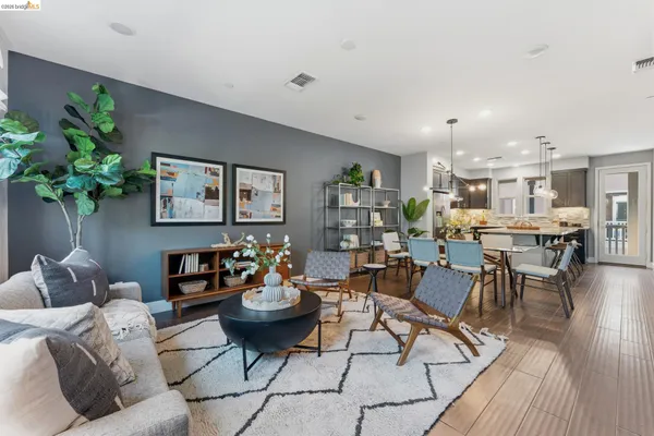 a living room with lots of furniture and a potted plant