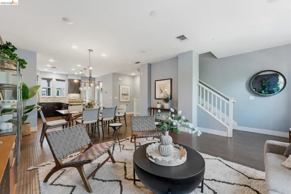 a view of a dining room with furniture and chandelier