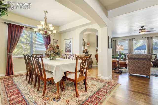 a view of a dining room with furniture wooden floor and chandelier