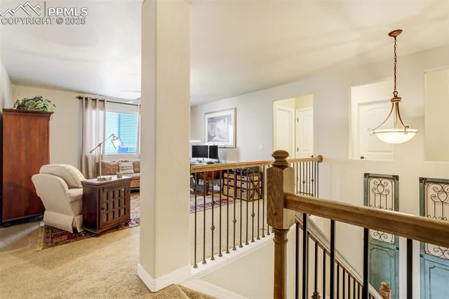 a view of a hallway with furniture and windows