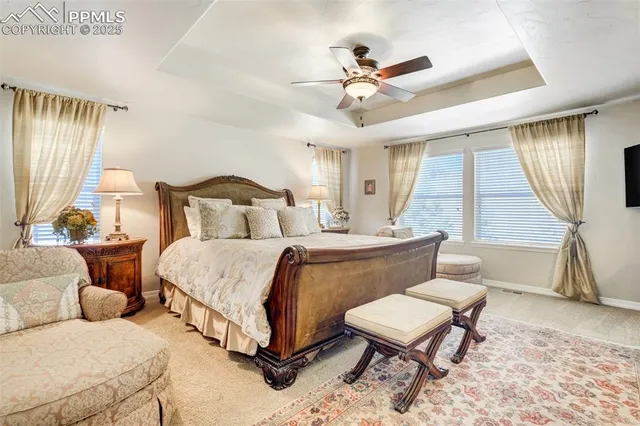 a bedroom with a bed a couch and potted plant