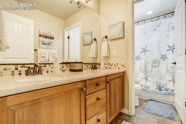 a bathroom with a double vanity sink mirror and shower