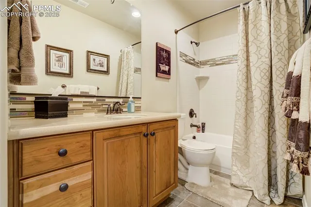 a bath room with a sink a toilet and a mirror