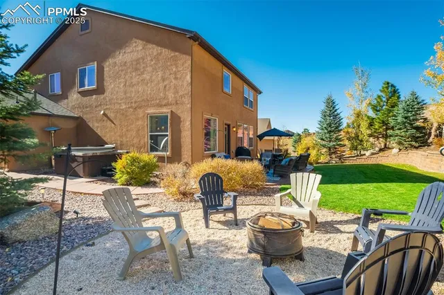 a view of a patio with table and chairs potted plants and a large tree