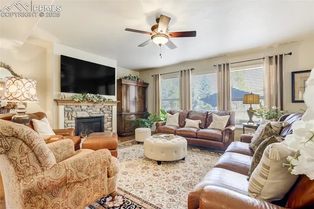 a living room with furniture a fireplace and a flat screen tv