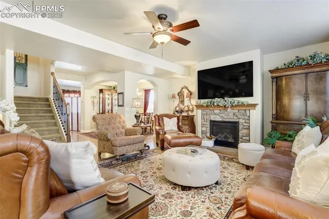 a living room with furniture a fireplace and a flat screen tv