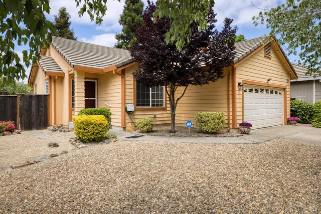 a view of a house with a yard and garage