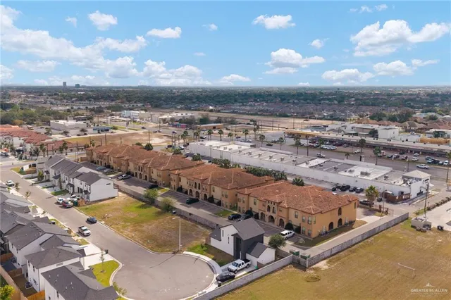an aerial view of residential houses with outdoor space