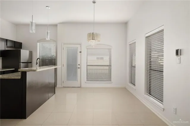 a view of empty room with a fireplace and cabinet
