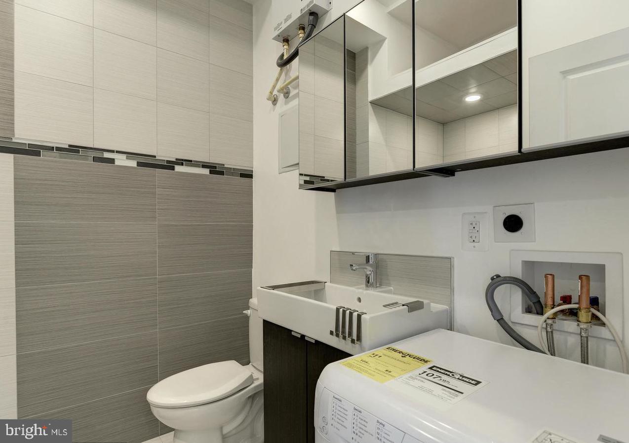 1102 5th Street Northwest, Unit 3 Washington, DC 20001 - Photo 7 of 11 a bathroom with a sink a toilet and shower