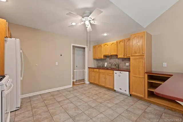 a kitchen with a refrigerator and a stove top oven