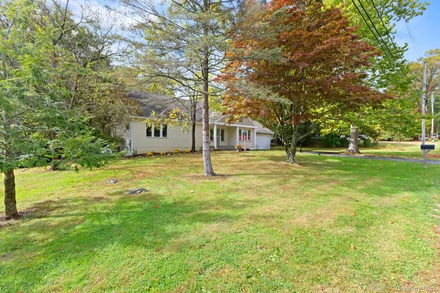 a view of a park with bench and trees