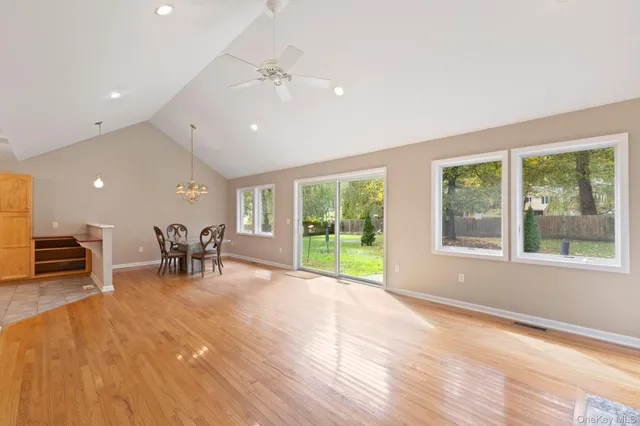 a view of a room with gym equipment and large windows