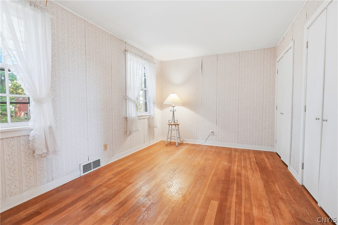 7779 Bell Road North Rome, NY 13440 - Photo 22 of 38 Gleaming hardwood floors and classic wall coverings highlight this versatile room filled with natural light.