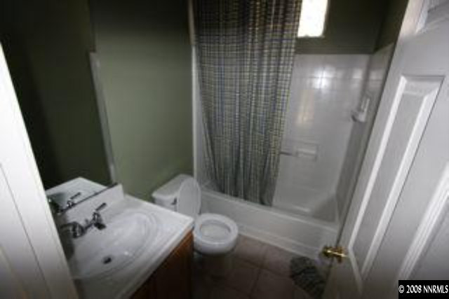 1113 Tule Drive Reno, NV 89521 - Photo 8 of 8 a bathroom with a sink and mirror with bathtub