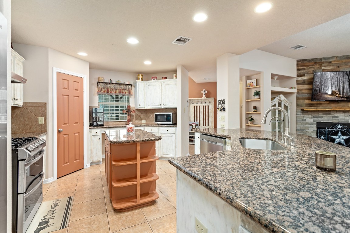 4985 Fm 2827 Road Warren, TX 77664 - Photo 13 of 41 a kitchen with stainless steel appliances granite countertop a stove oven and a refrigerator