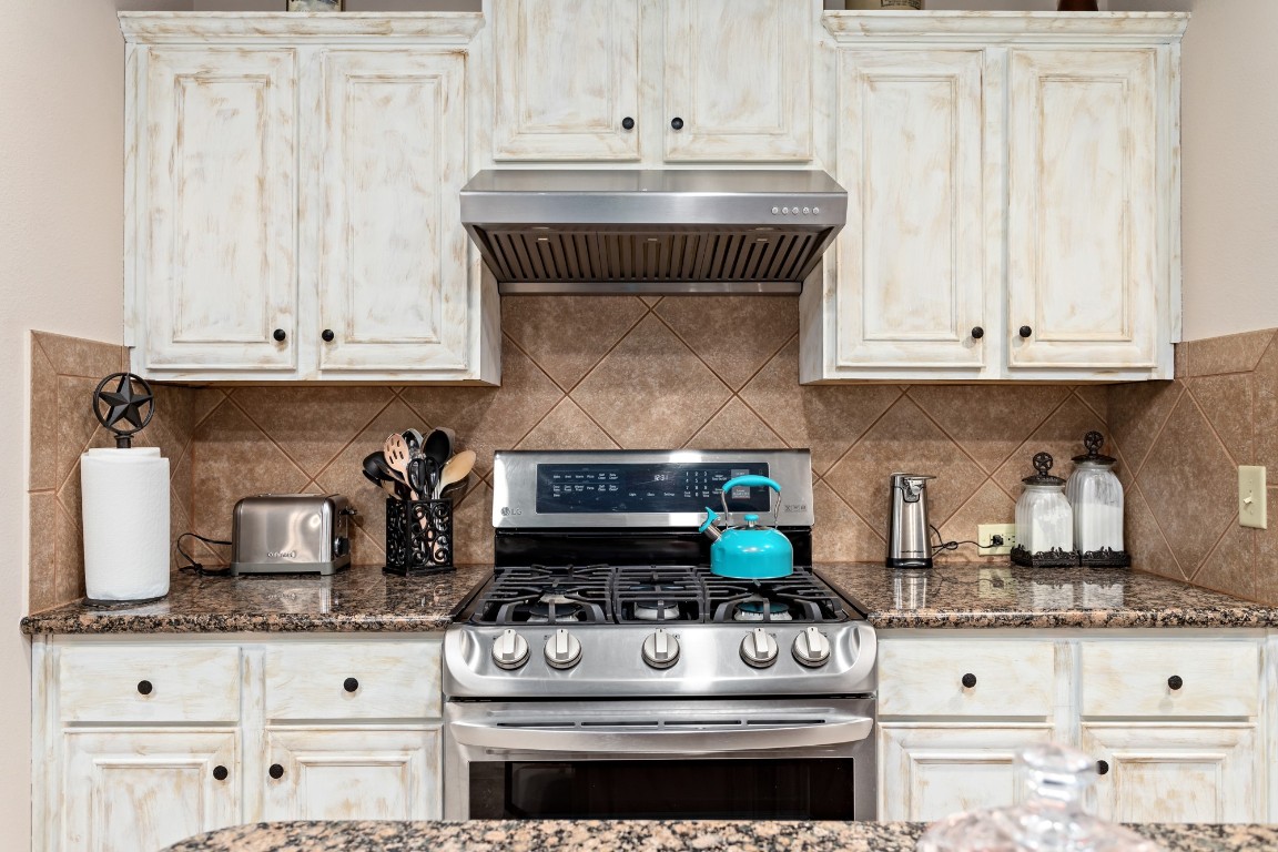 4985 Fm 2827 Road Warren, TX 77664 - Photo 15 of 41 a stove top oven sitting inside of a kitchen and white cabinets