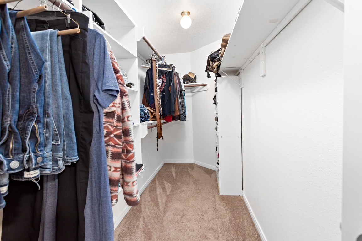 4985 Fm 2827 Road Warren, TX 77664 - Photo 20 of 41 a view of walk in closet with clothes