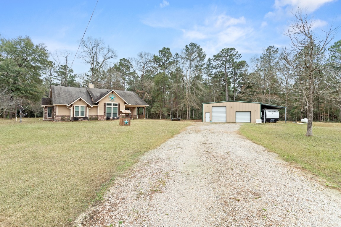 4985 Fm 2827 Road Warren, TX 77664 - Photo 2 of 41 a view of a house with a yard and garage
