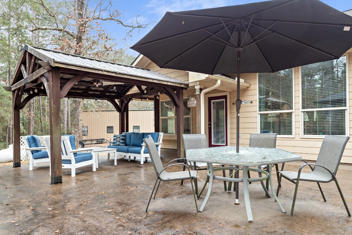 4985 Fm 2827 Road Warren, TX 77664 - Photo 26 of 41 a view of an outdoor sitting area with furniture and umbrella