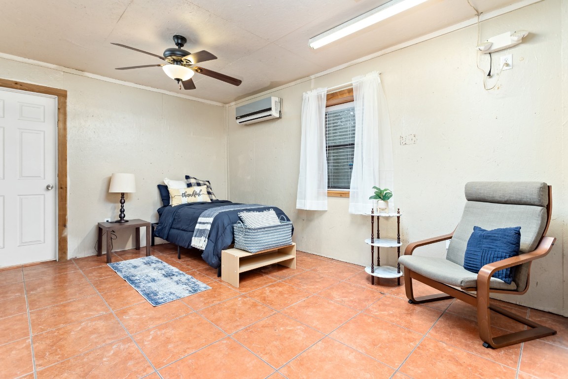 4985 Fm 2827 Road Warren, TX 77664 - Photo 35 of 41 a bedroom with a bed a chair and potted plant on the dresser