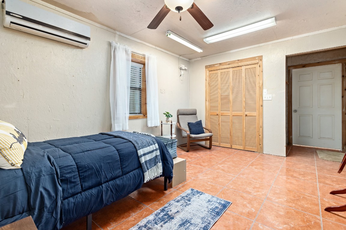 4985 Fm 2827 Road Warren, TX 77664 - Photo 36 of 41 a spacious bedroom with a bed a table and painting