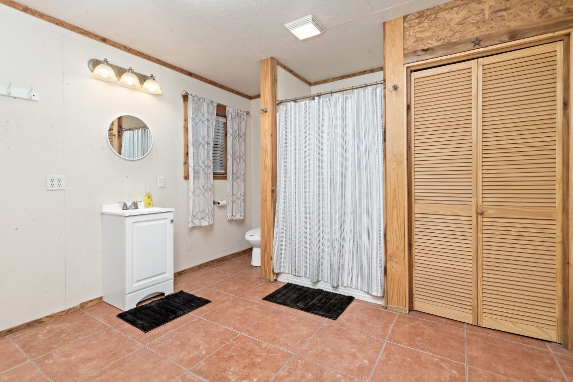 4985 Fm 2827 Road Warren, TX 77664 - Photo 38 of 41 a view of walk in closet with clothes and shoes