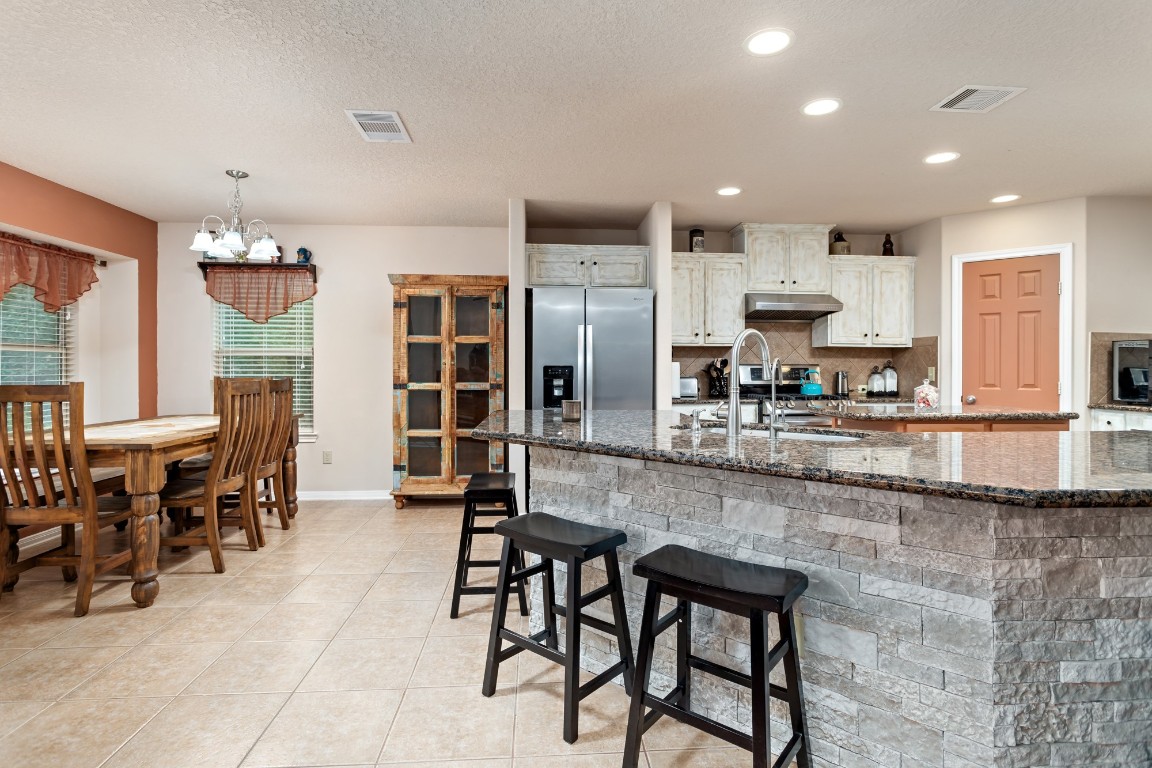 4985 Fm 2827 Road Warren, TX 77664 - Photo 10 of 41 a kitchen with stainless steel appliances kitchen island granite top and refrigerator