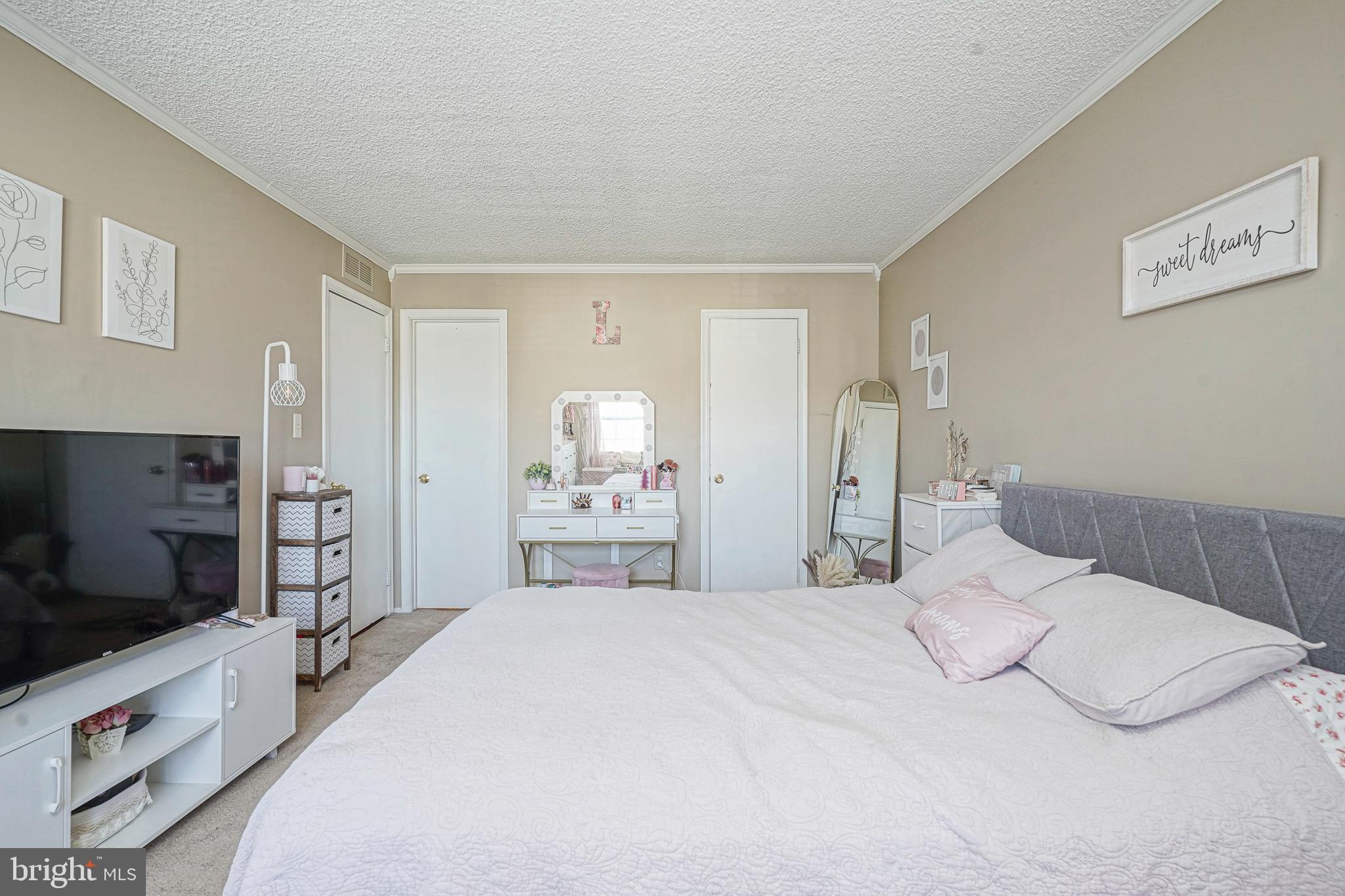 2402 Sedgefield Drive Mount Laurel, NJ 08054 - Photo 12 of 22 a bedroom with a bed and a flat screen tv