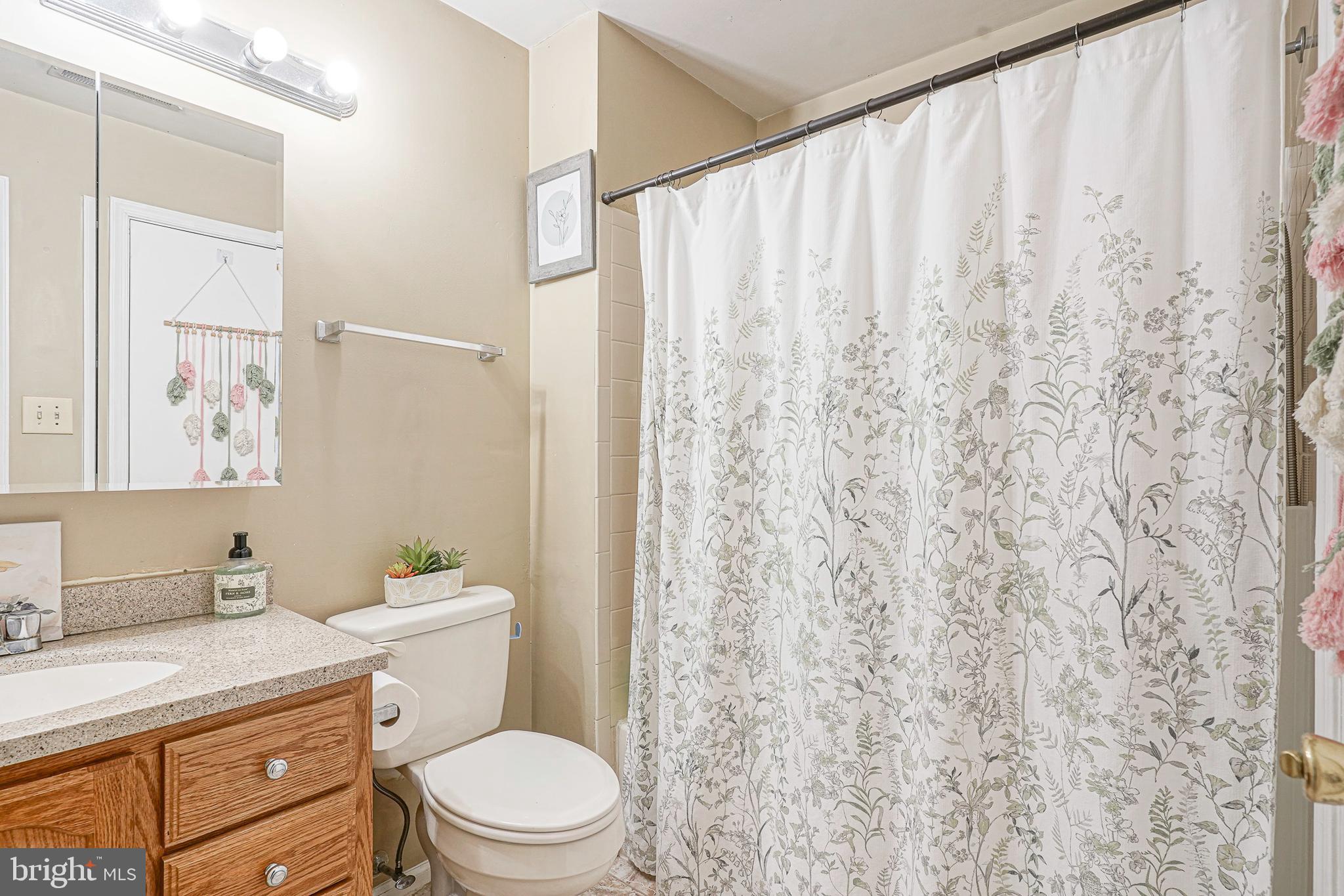 2402 Sedgefield Drive Mount Laurel, NJ 08054 - Photo 16 of 22 a white toilet sitting next to a bathroom sink