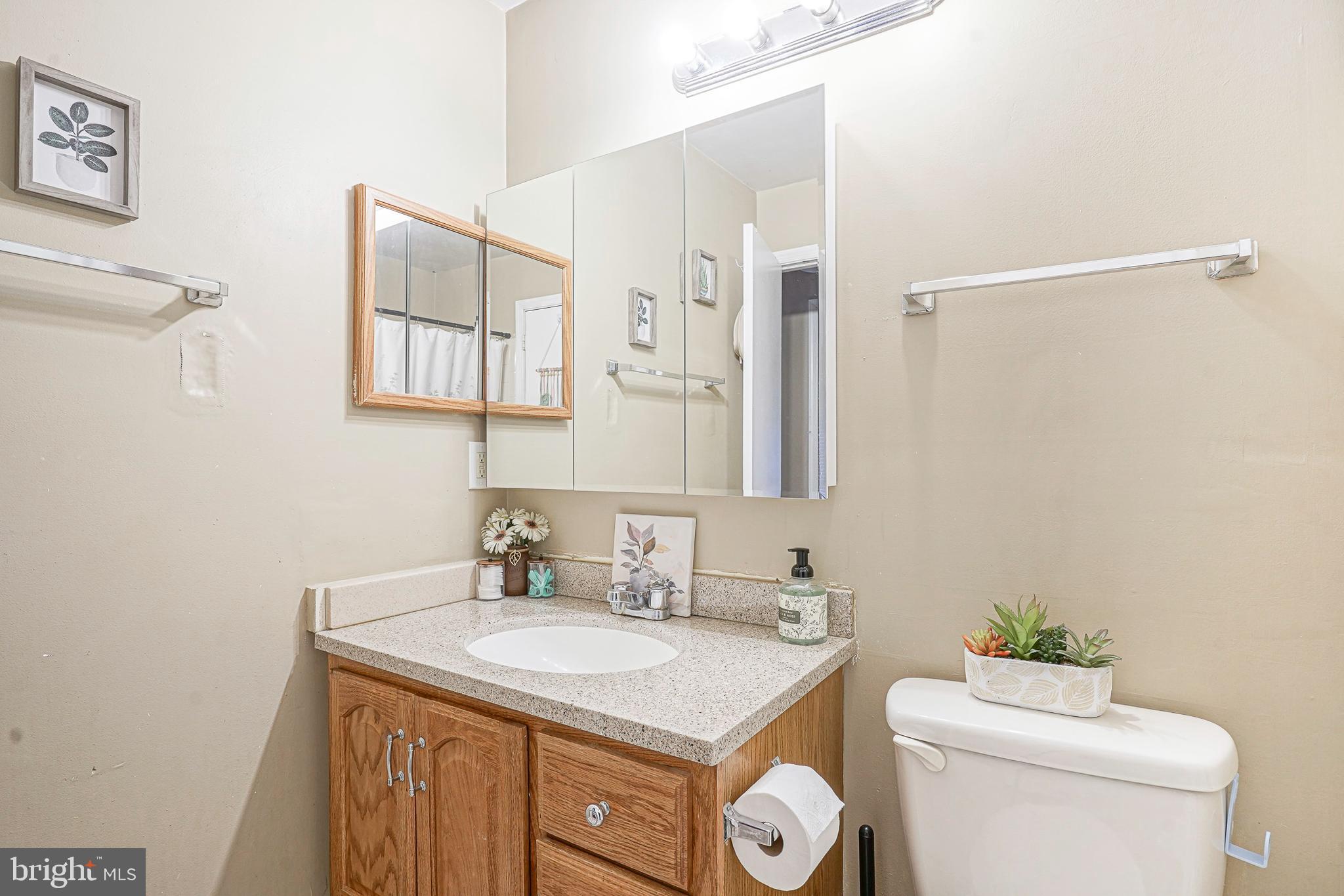 2402 Sedgefield Drive Mount Laurel, NJ 08054 - Photo 17 of 22 a bathroom with a granite countertop sink a toilet and a mirror