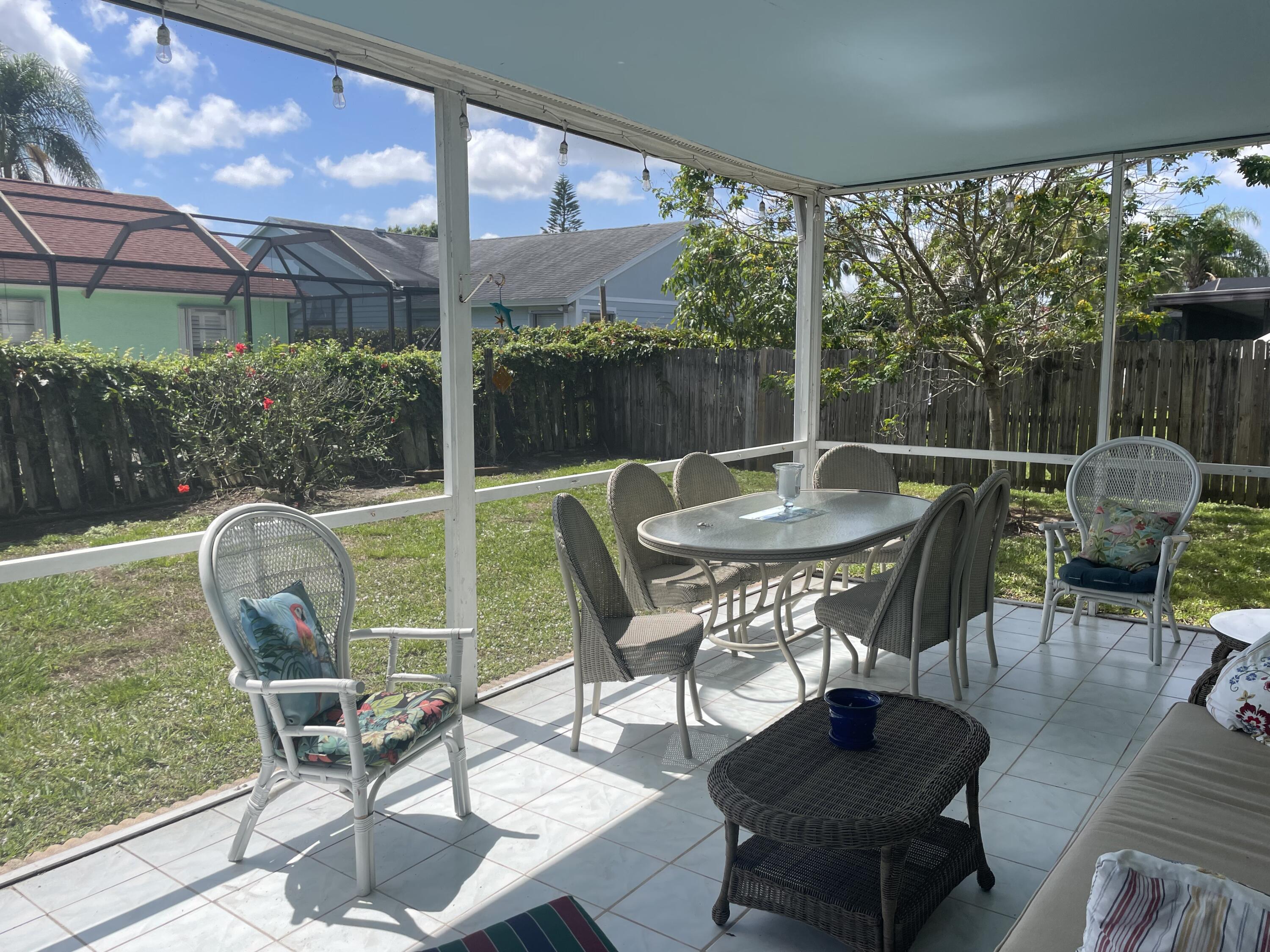 108 Greenbriar Drive Jupiter, FL 33458 - Photo 2 of 8 a view of a chairs and table in the patio